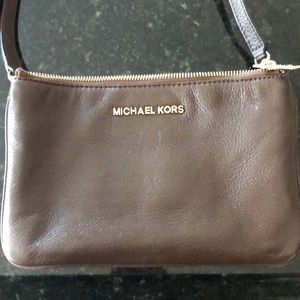 Michael Kors purse in brown with gold detailing.